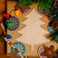Wooden Christmas tree decoration with decorative items on a wooden surface