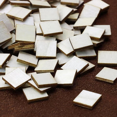 Collection of small square tiles on a brown surface
