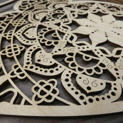 Wooden decorative panel with intricate cut-out patterns on a dark surface