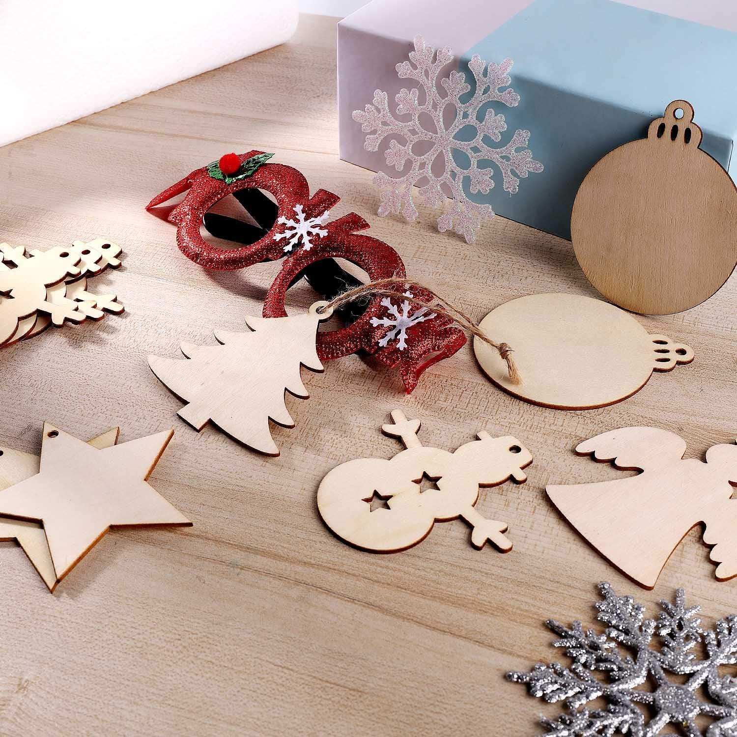 Wooden Christmas ornaments on a wooden surface with a decorative box in the background.