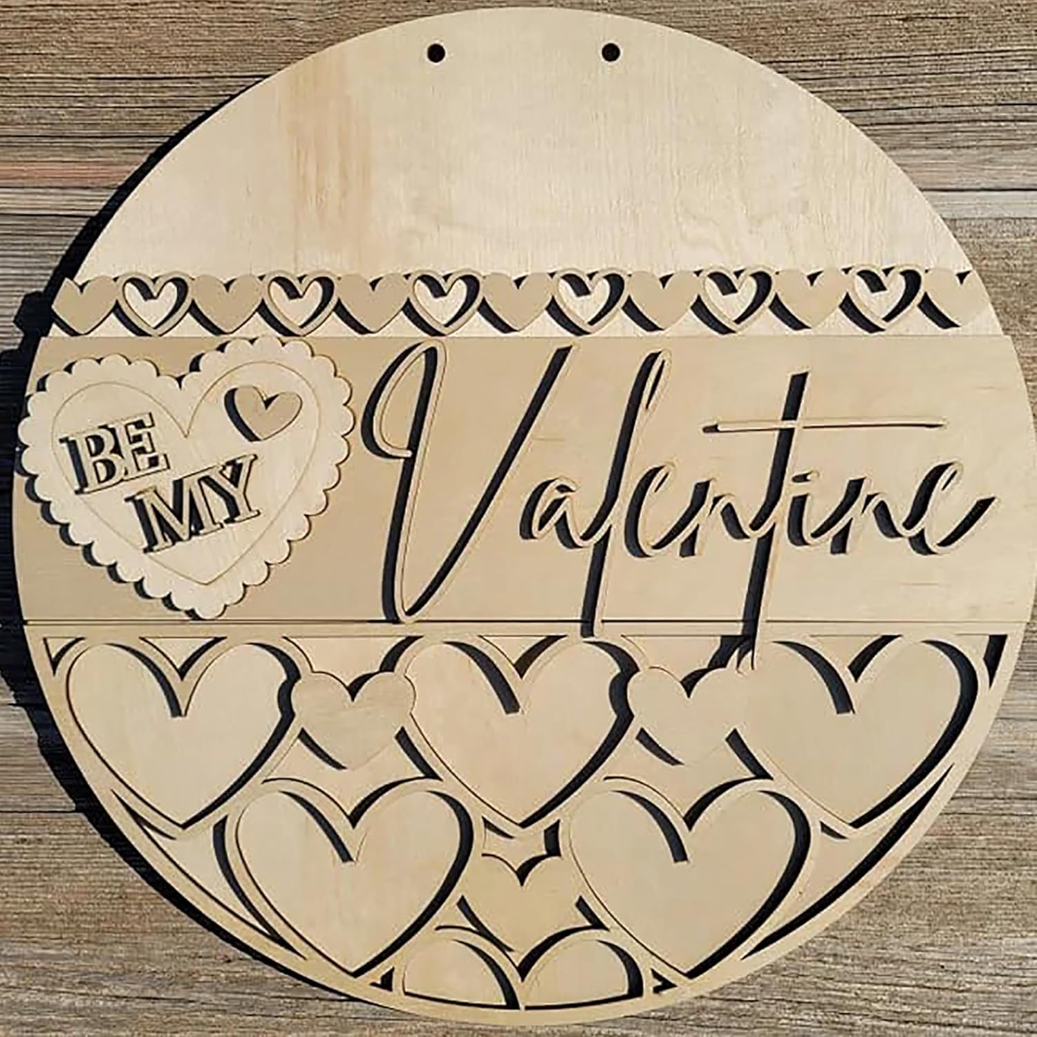 Wooden heart-shaped sign with 'Be My Valentine' text on a wooden background