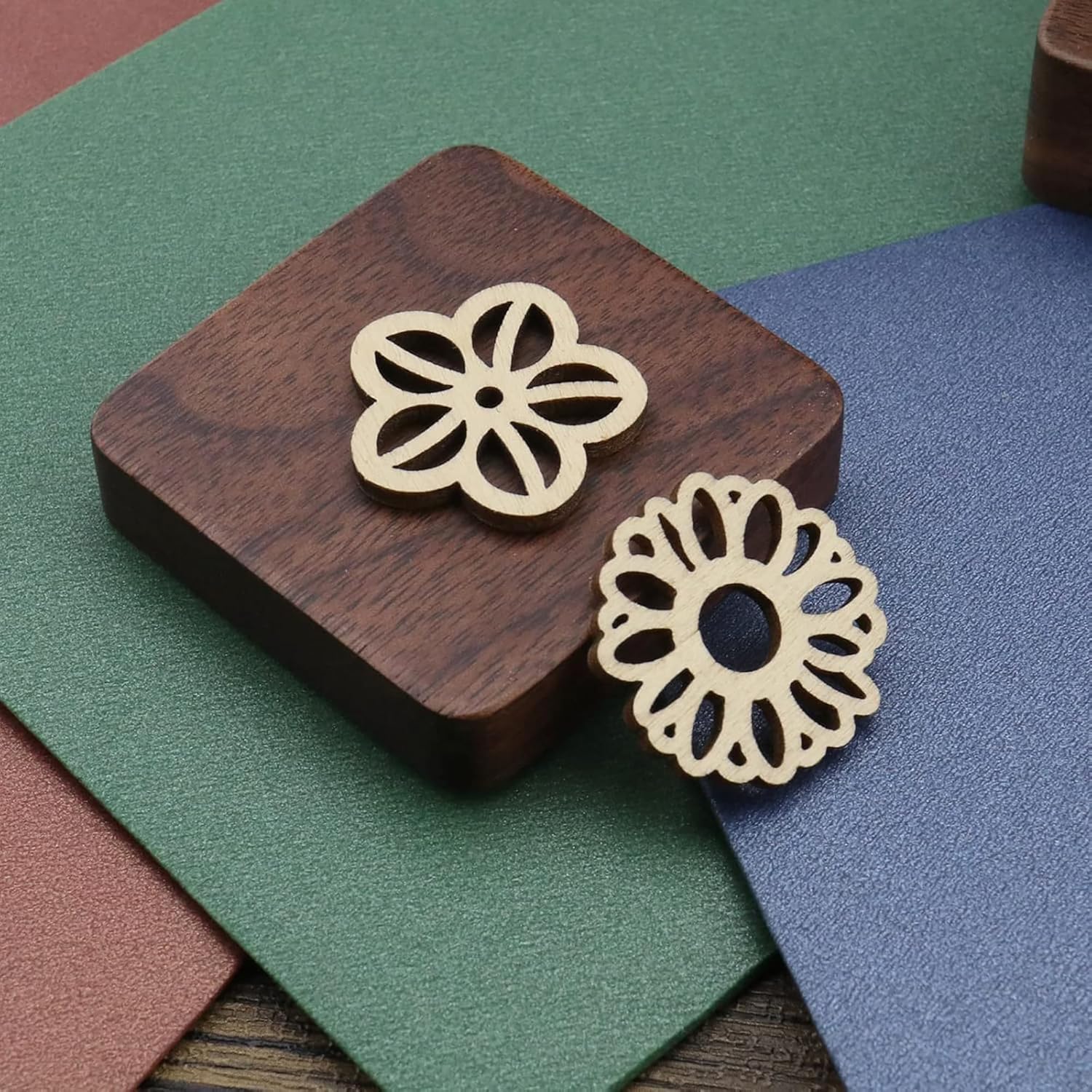 Gold floral earrings on a wooden stand with a colorful background