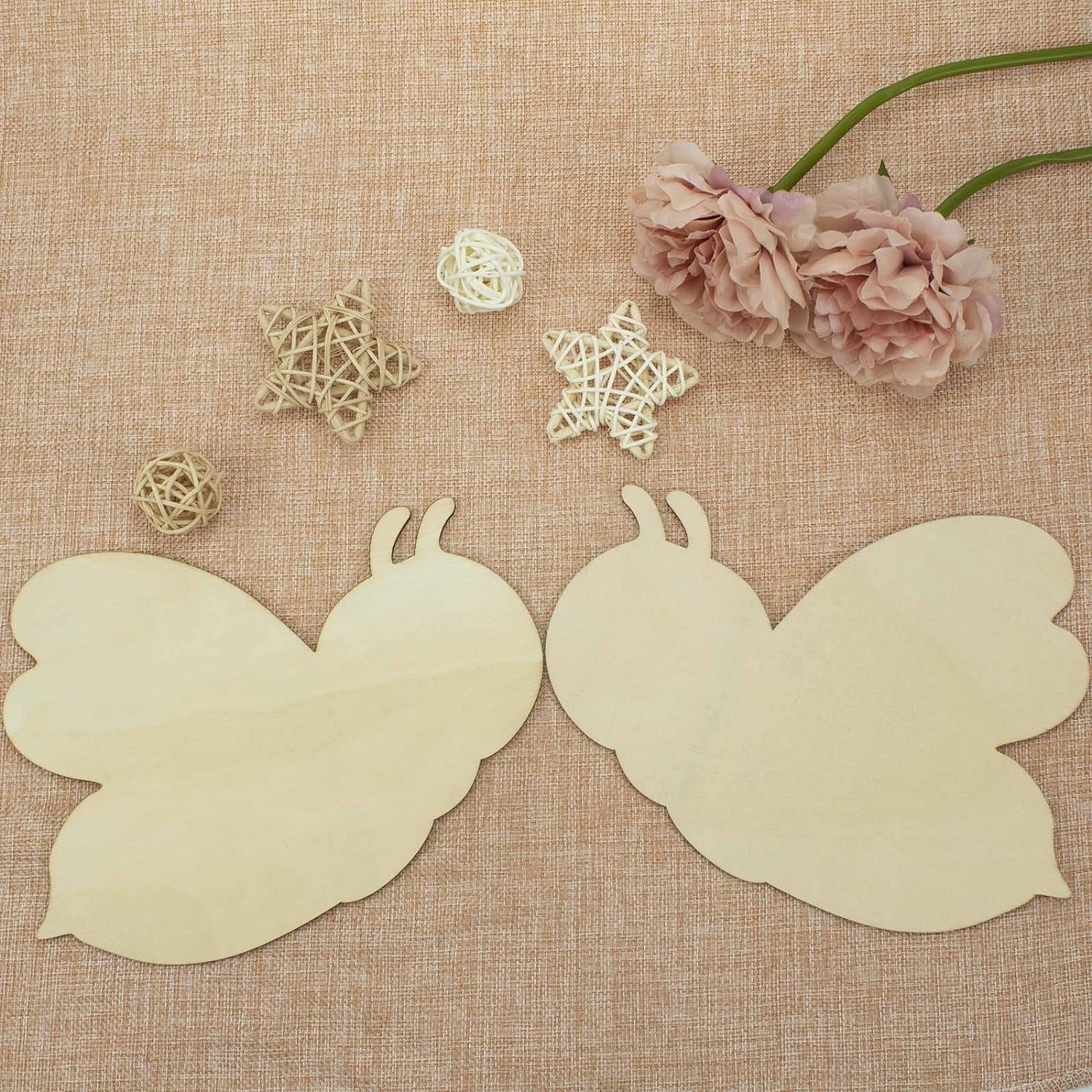 Butterfly wings on a textured fabric background with decorative elements.