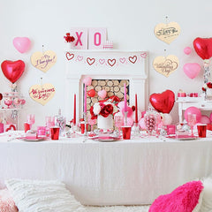 Valentine's Day themed room with balloons, flowers, and decorations.