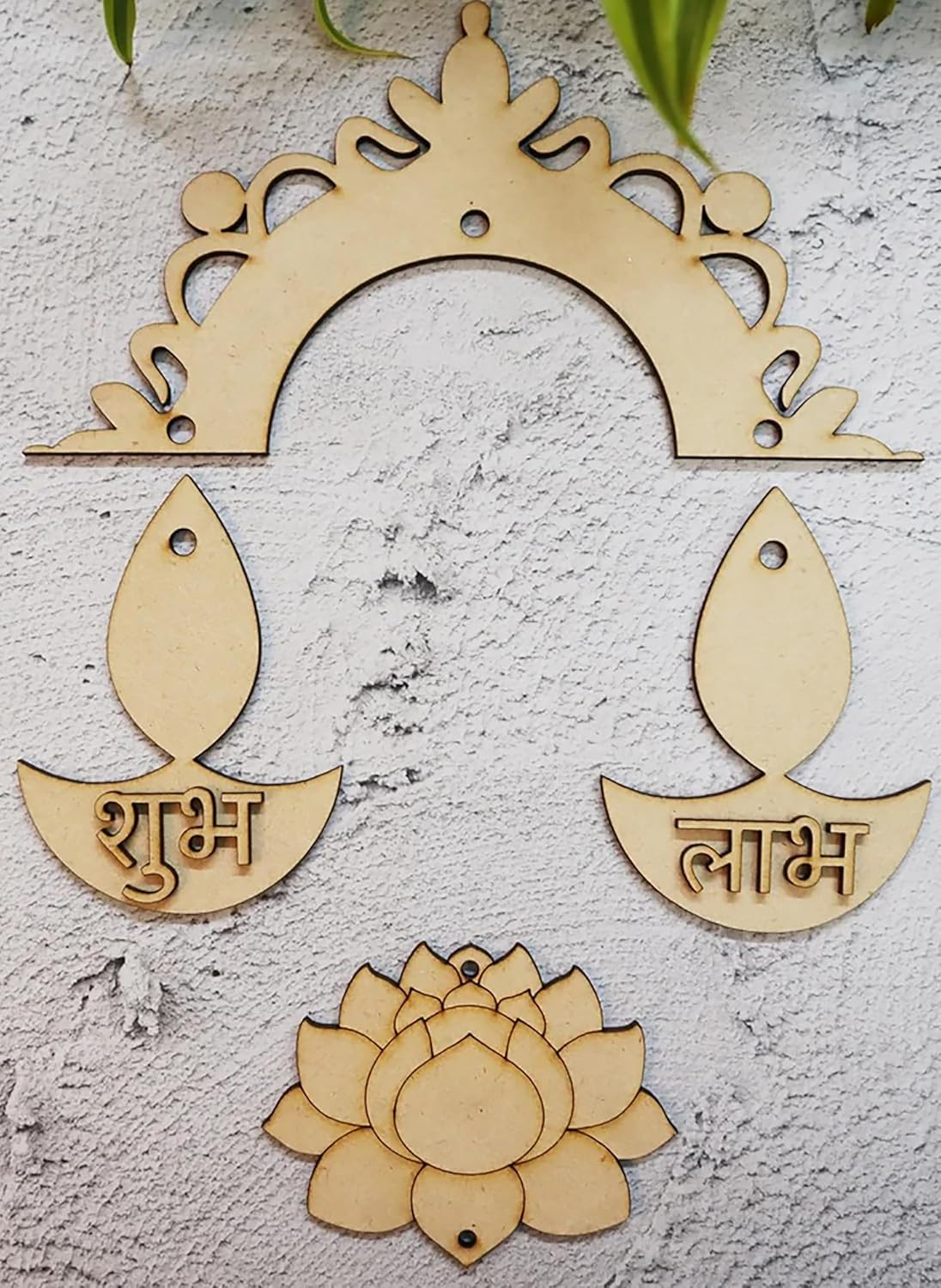 Wooden decorative items with arch, fish shapes, and lotus on a textured surface