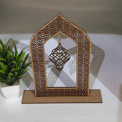 Decorative wooden frame with intricate patterns on a white surface with a plant in the background