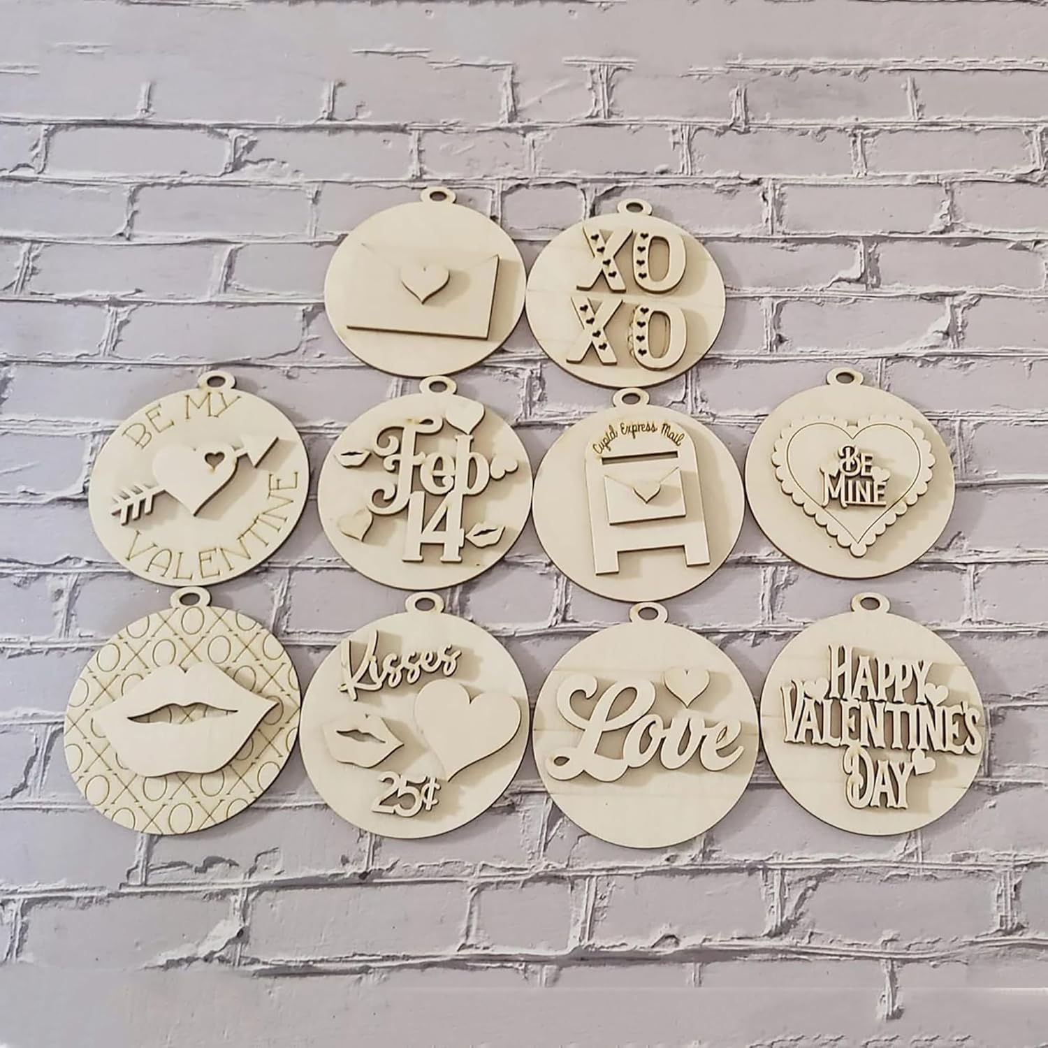Decorative wooden ornaments with various inscriptions on a gray brick wall background