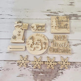 Set of wooden Christmas decorations with text and snowflake designs on a rustic wooden background.