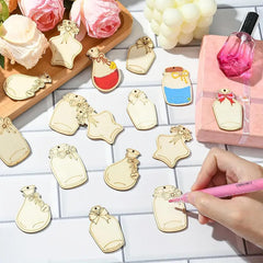 Decorative bottle-shaped charms on a table with a hand holding a pink pen.