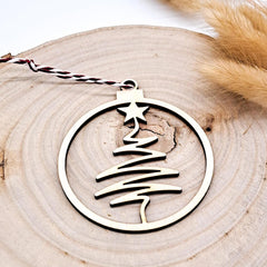 Decorative Christmas tree ornament with a star on a wooden surface