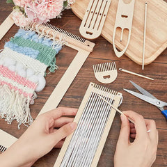Handmade weaving project with tools and materials on a wooden surface