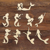 Silhouettes of mermaids on a wooden surface