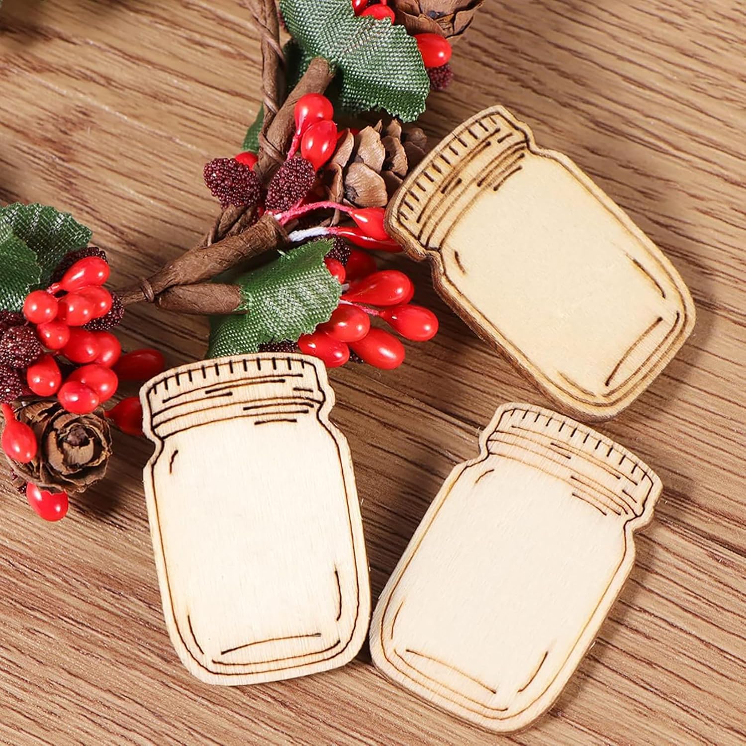 Wooden mason jar ornaments on a wooden surface with decorative elements.