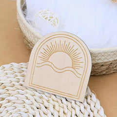 Beige card with sun and wave design on a woven surface