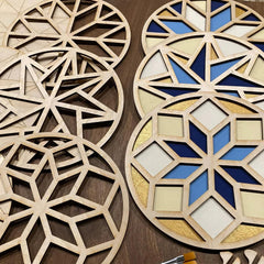 Decorative wooden panels with geometric patterns on a wooden surface