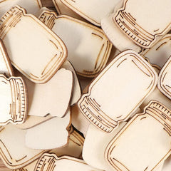 Close-up of wooden cutouts shaped like bottles with caps.