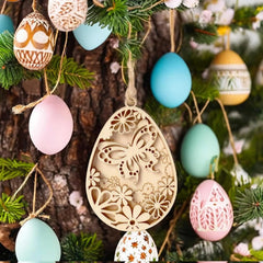 Decorative Easter egg ornaments with intricate designs hanging on a tree.