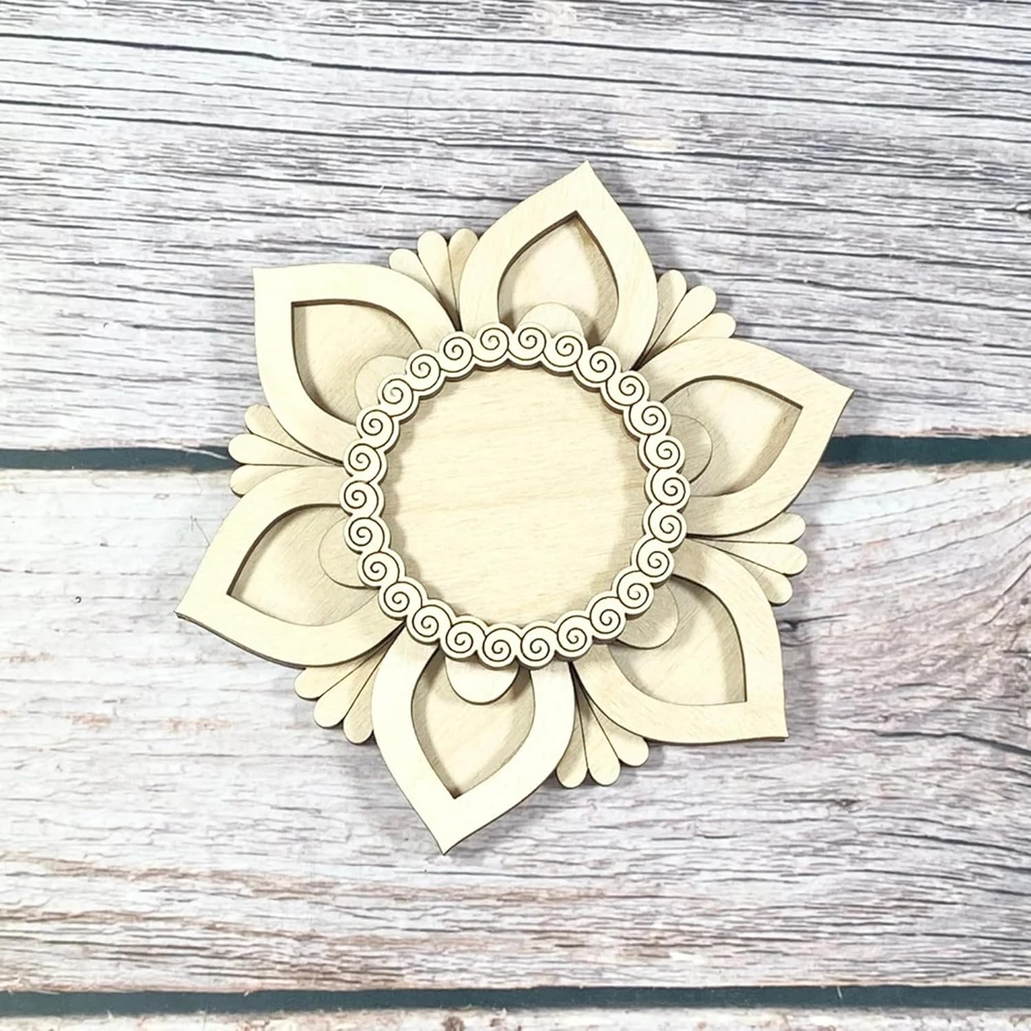 Decorative wall piece with floral design on a wooden surface