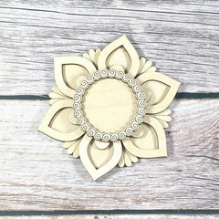 Decorative wall piece with floral design on a wooden surface