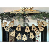 Wooden 'Merry Christmas' banner hanging on a decorated fireplace mantel.