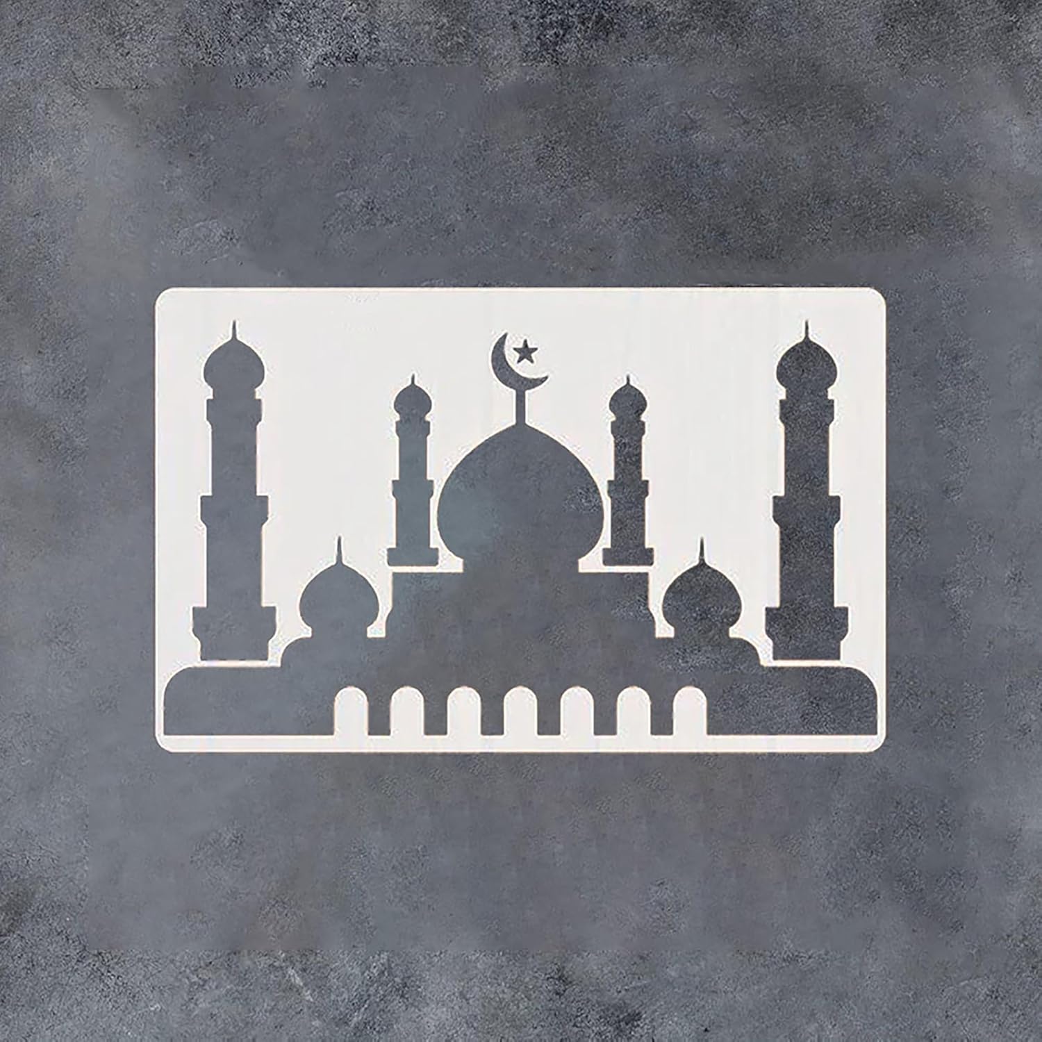Silhouette of a mosque with minarets and a dome on a textured gray background