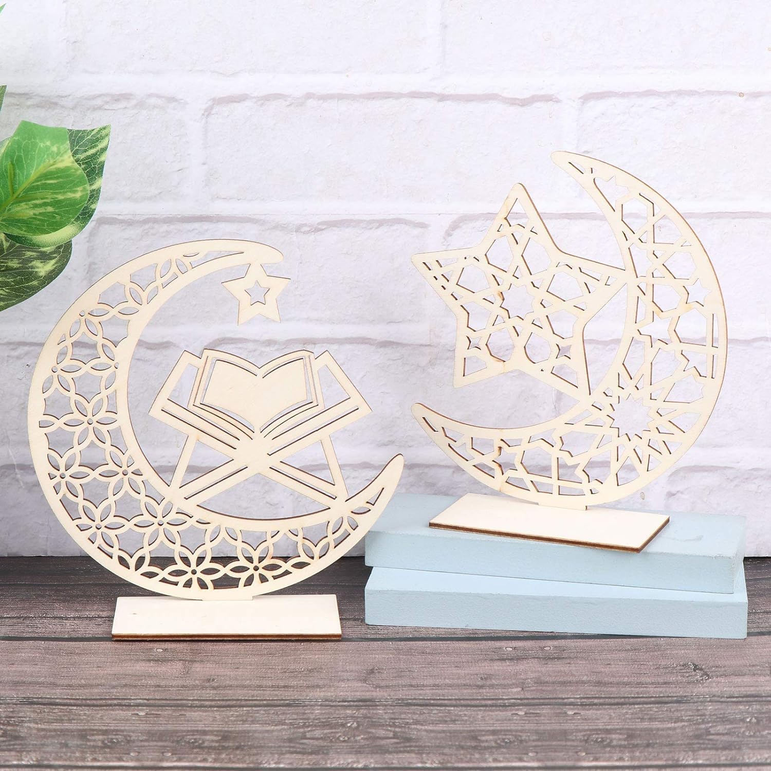 Decorative wooden moon and star designs on stands against a light background