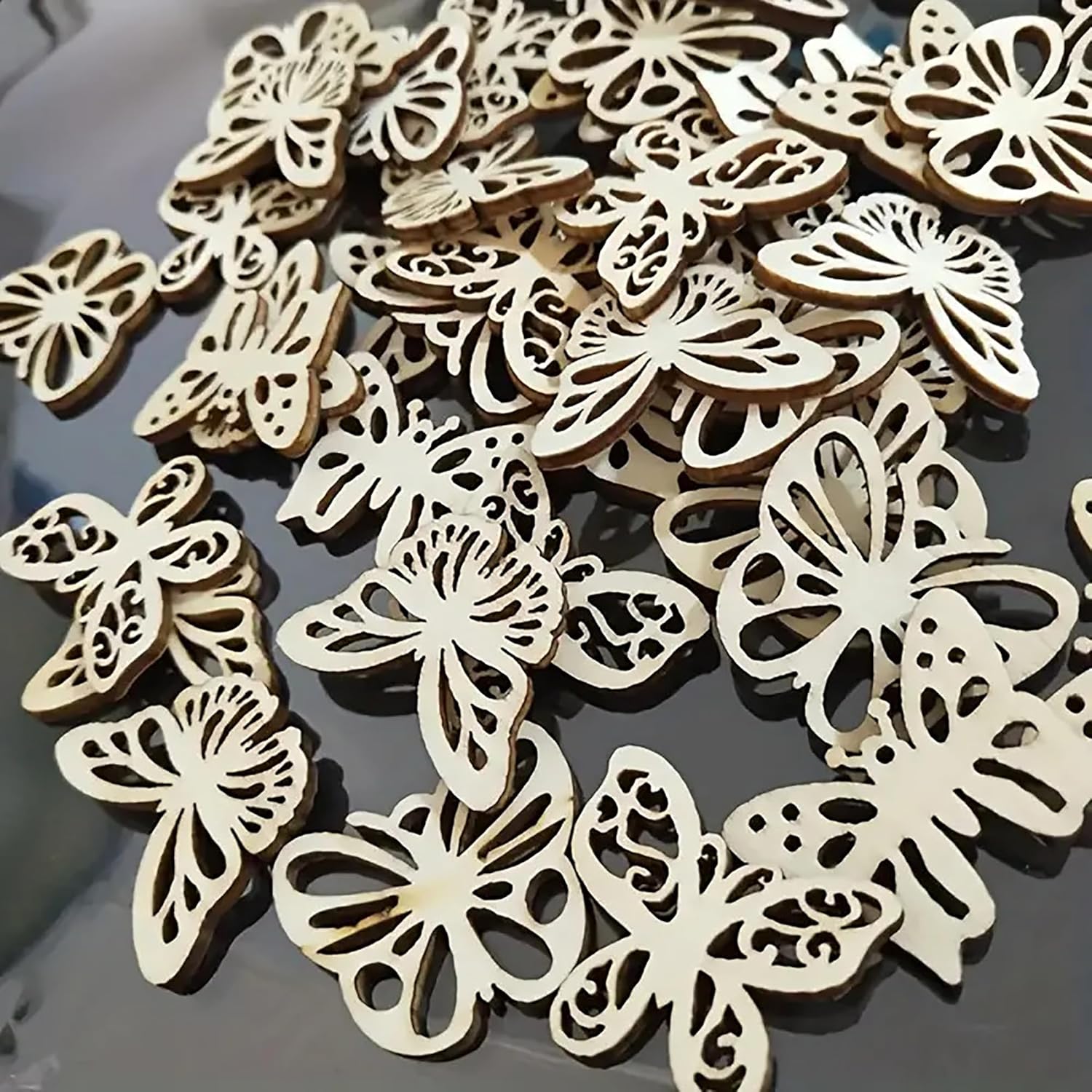 Wooden butterfly decorations on a dark surface