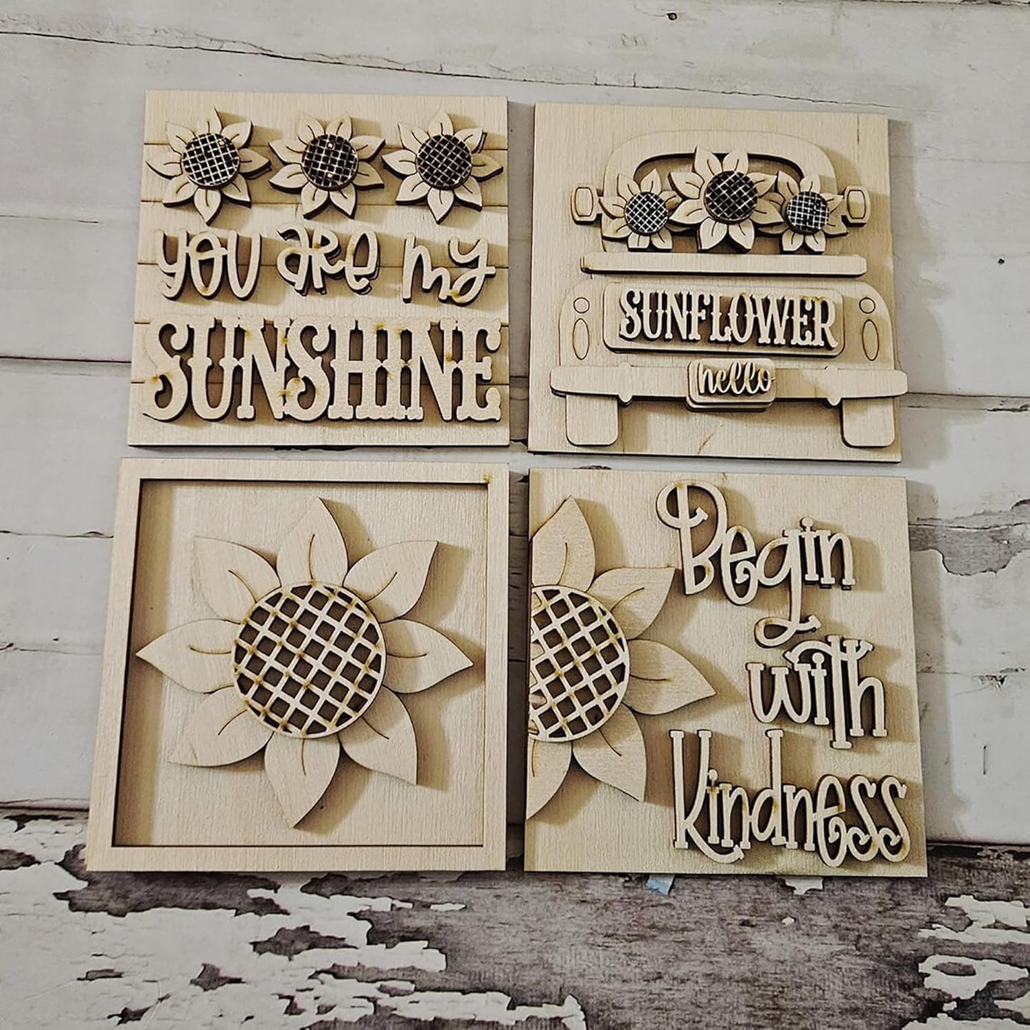 Wooden wall art pieces with sunflower designs and text on a rustic wooden background.