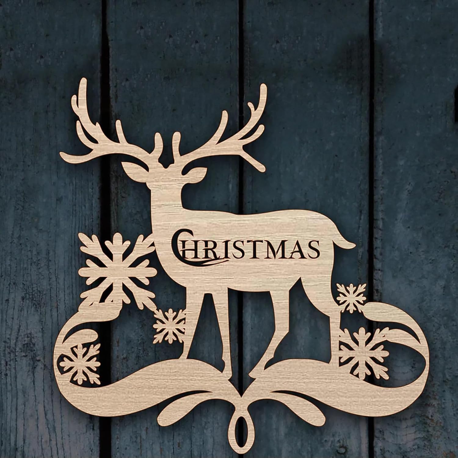 Wooden reindeer decoration with 'Christmas' text on a dark wooden background