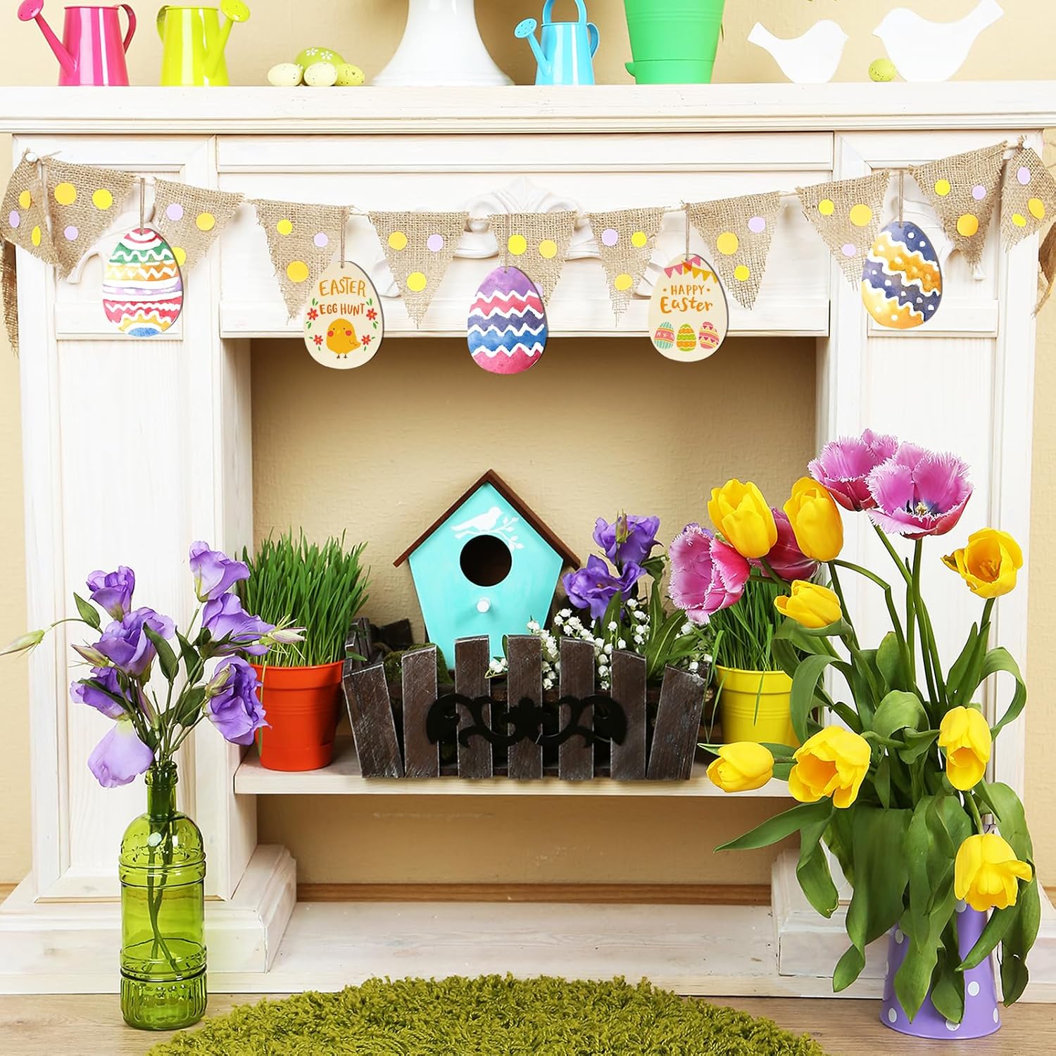Decorative Easter shelf with flowers, birdhouse, and bunting on a white fireplace.