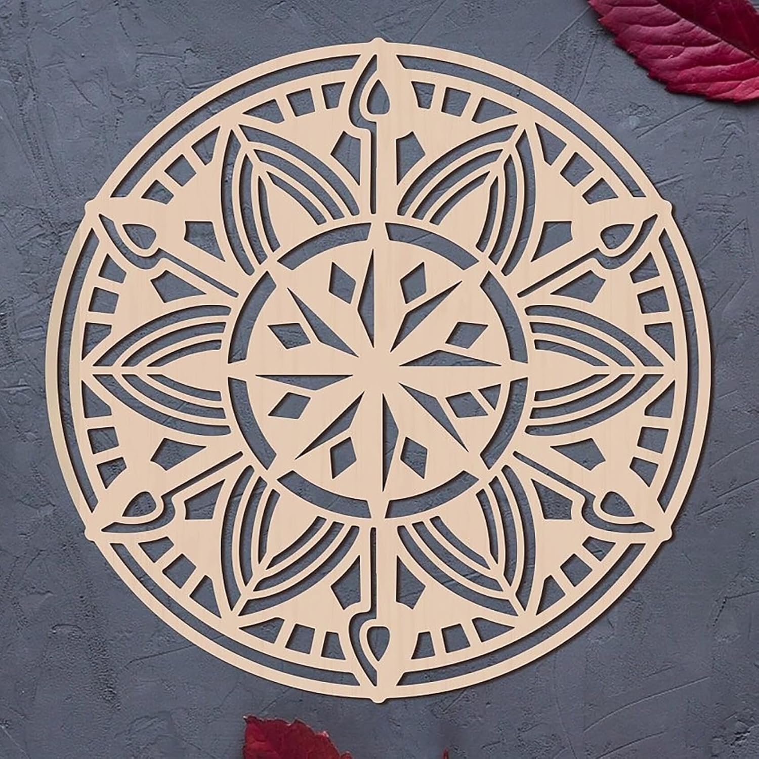 Decorative mandala cutout on a textured gray surface
