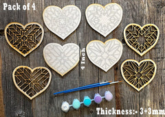 Pack of 4 geometric heart-shaped wooden cutouts with paint and brush on a wooden surface
