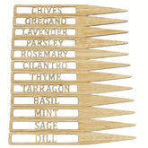 Set of wooden garden markers with herb names engraved on them.