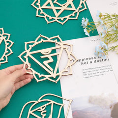 Wooden decorative pieces on a green surface with text and flowers