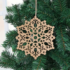 Decorative snowflake ornament hanging on a Christmas tree