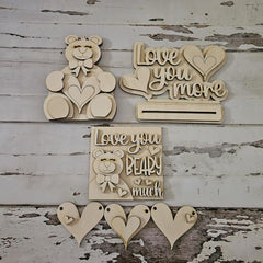 Wooden decorative signs with teddy bears and text on a rustic wooden background