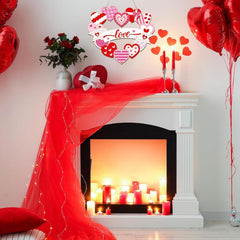 Decorated room with a fireplace, red balloons, and heart-themed decorations.
