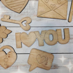 Wooden cutouts of 'I love you' on a wooden surface