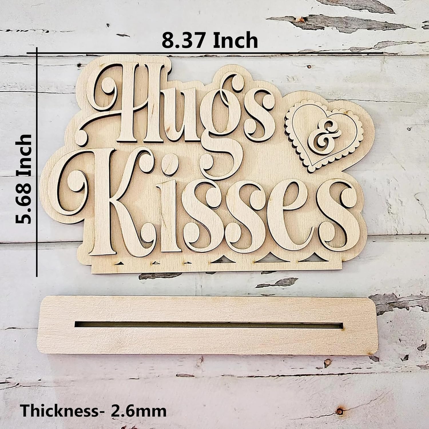 Wooden decorative sign with 'Hugs & Kisses' text and measurements on a rustic wooden background