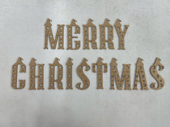 Decorative wooden cutout letters spelling 'Merry Christmas' on a textured surface.