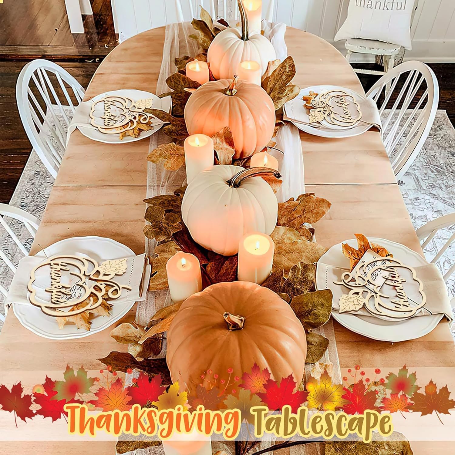 Thanksgiving tablescape with pumpkins, candles, and fall decorations on a wooden table.