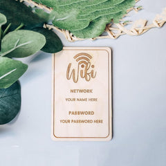 Wooden WiFi password sign with leaves on a light blue background