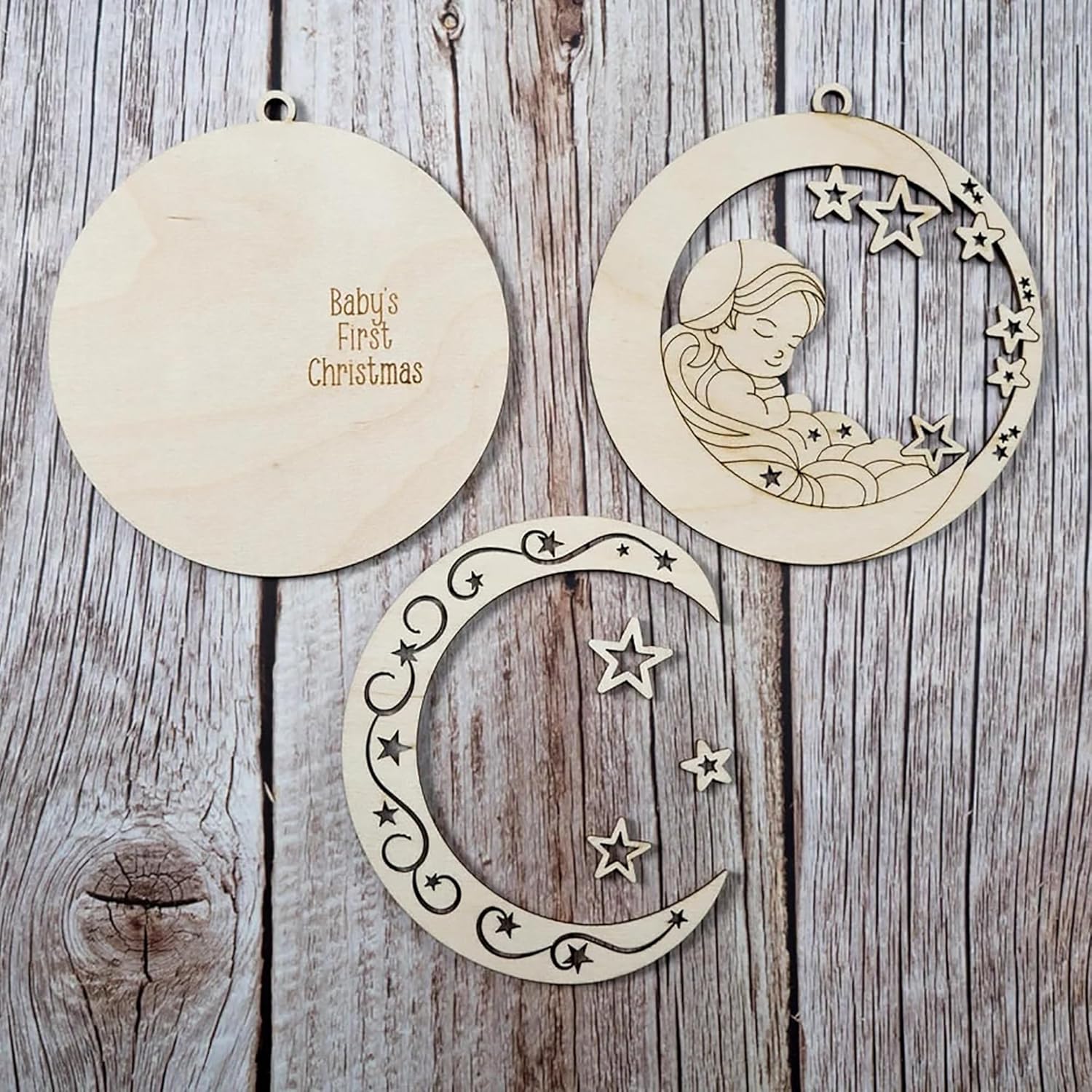 Wooden ornaments with moon and star designs on a wooden surface