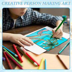 Child drawing with colored pencils on a piece of paper
