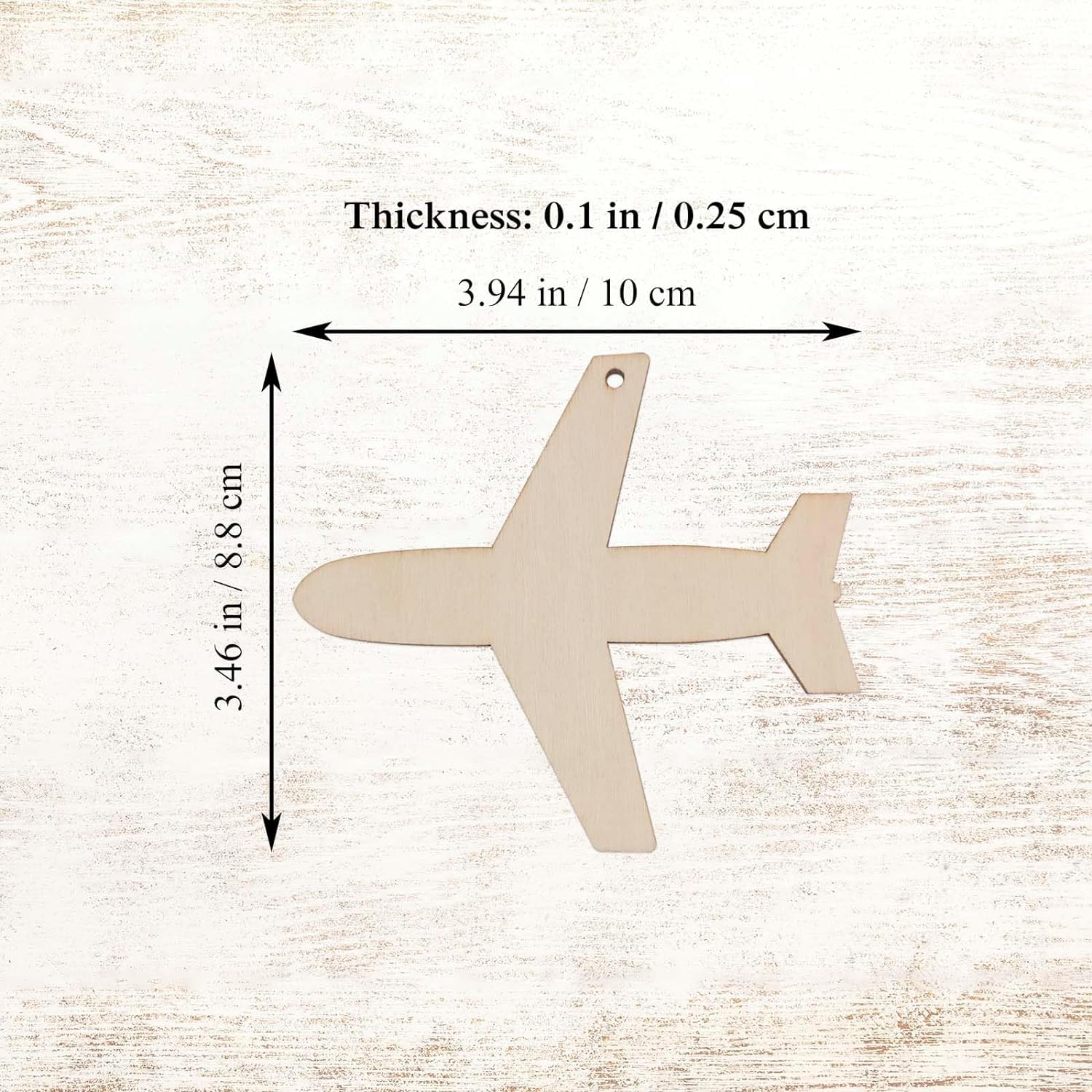 Unfinished wood airplane shape with measurements on a light wooden background