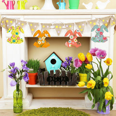 Decorative Easter shelf with colorful bunnies, birdhouse, and flowers.