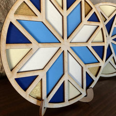 Geometric wooden design with blue, white, and gold colors on a dark surface