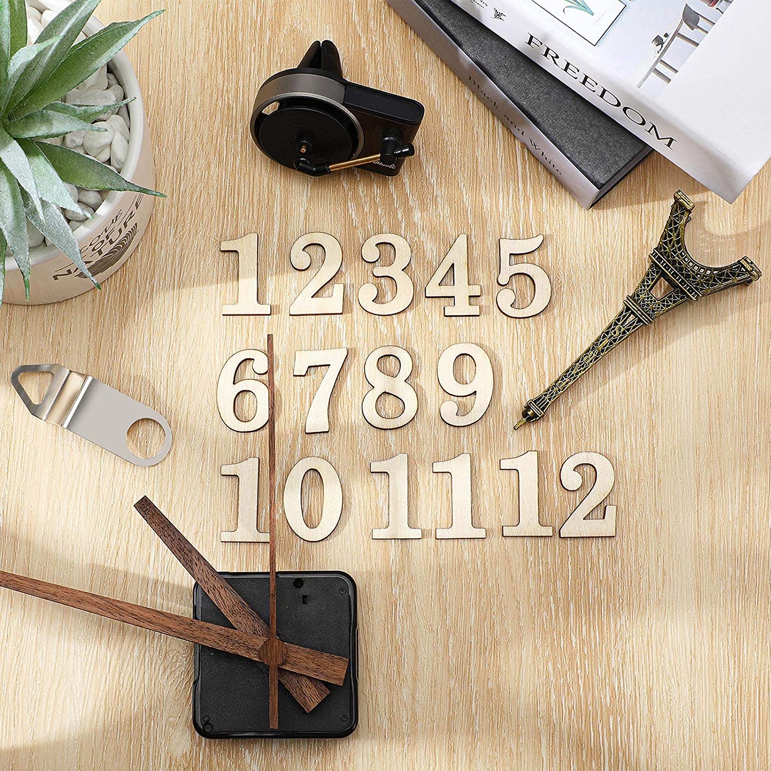 Wooden numbers on a wooden surface with a plant and book in the background