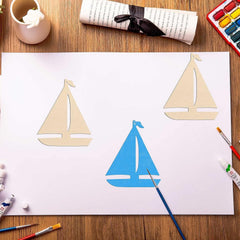 Children's drawing of sailboats on a piece of paper with art supplies around.