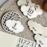 Baby milestone cards with numbers on a textured surface